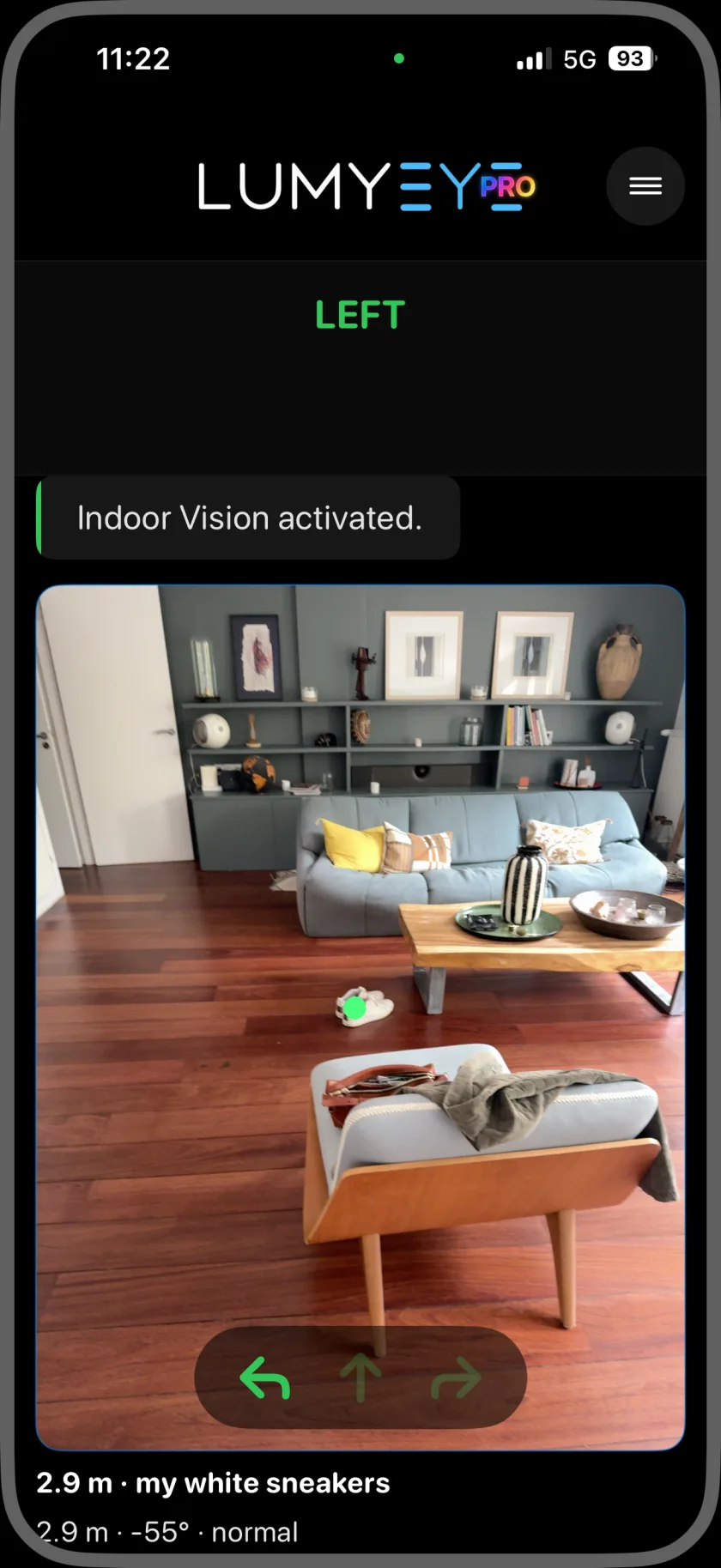Lumyeye Pro Indoor Vision camera view of a living room. A green marker highlights white sneakers, and the screen reads 2.9 m · my white sneakers with a left arrow for direction.